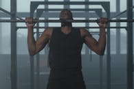 Man in Black Tank Top Holding Gray Barbell