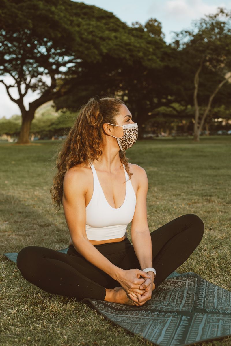 Woman stretching on a yoga mat in sportswear