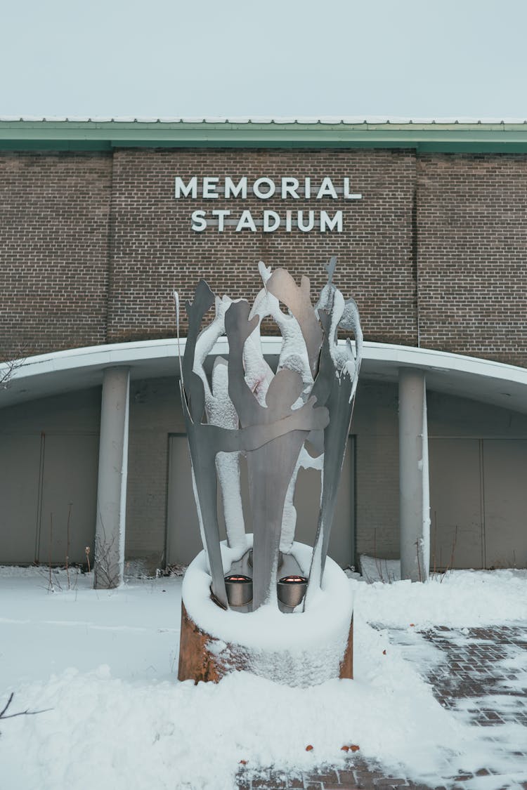 Monument Against Memorial Stadium In Winter Town