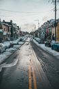 Asphalt road between dwelling houses in winter town