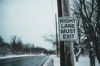 Road sign with inscription on post in winter town