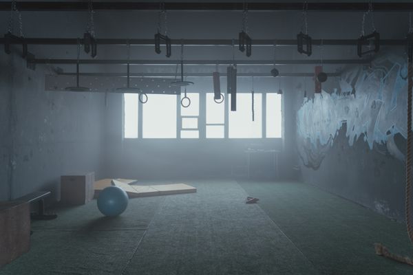 Empty industrial-style gym room with fitness equipment
