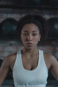 Portrait of a confident woman in activewear standing in a gym