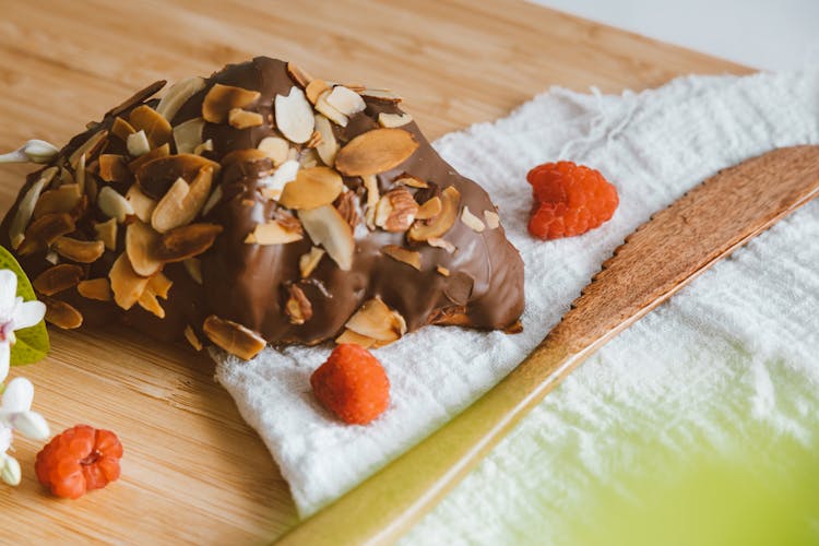 Croissant With Chocolate Icing And Almond Flakes 