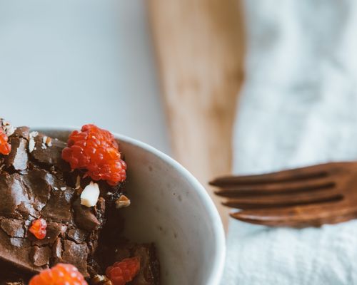 Free Close-up of a chocolate brownie topped with fresh raspberries, perfect for dessert lovers. Stock Photo