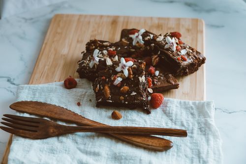 Free Satisfy your sweet cravings with rich chocolate brownies topped with almonds and raspberries. Stock Photo