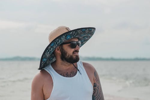 Man in White Tank Top Wearing a Hat