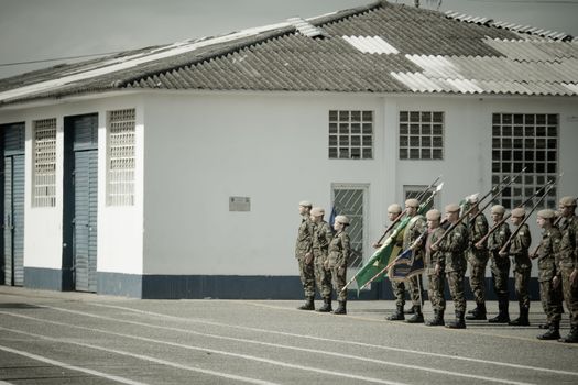 Unit of Soldiers during Drill Standing in Ranks by Military Barracks