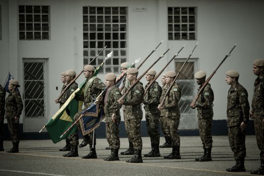Soldiers with Bayonets and a Banner during a Military Parade 
