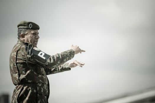 Military Police Officer Gesturing During a Military Ceremony 