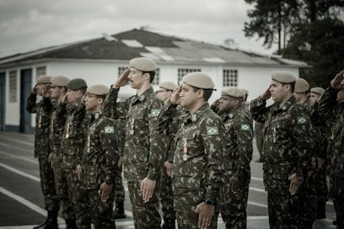 Free Soldiers in Military Uniforms Saluting Stock Photo