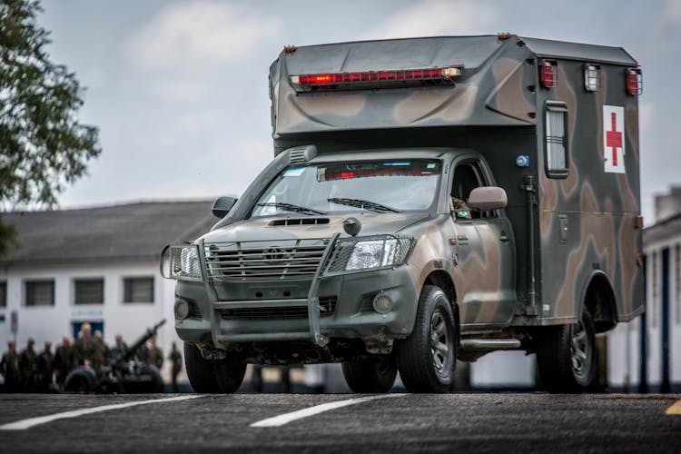 Military Ambulance Driving On Road