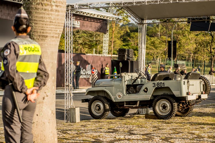 Brazilina Military Vintage Jeep Willis Guarded By A Millitary Police Officer