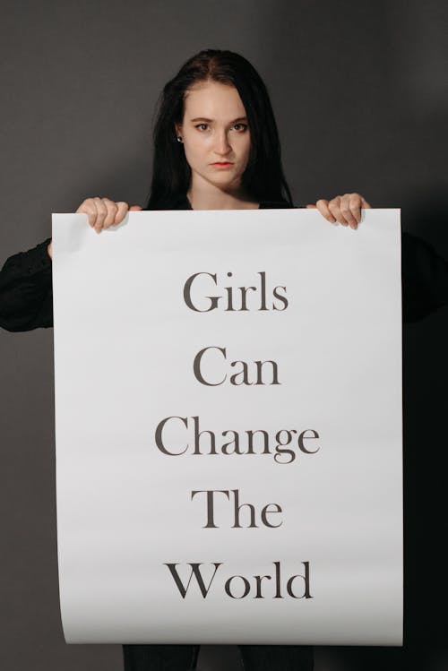 A Woman Holding a Sign Board