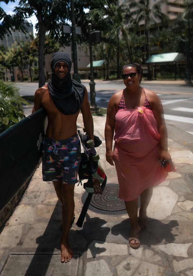 Black Couple In Swimwear Walking In Street