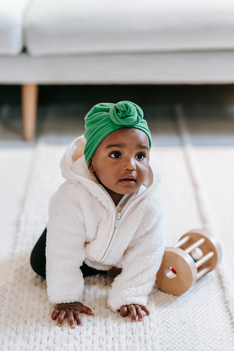 Funny Baby Indian Girl Crawling On Floor With Toy