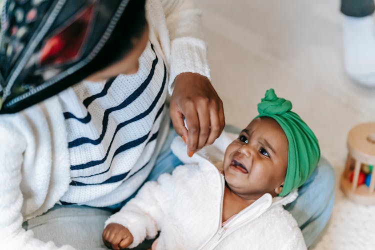 Anonymous Ethnic Mother Embracing Crying Baby