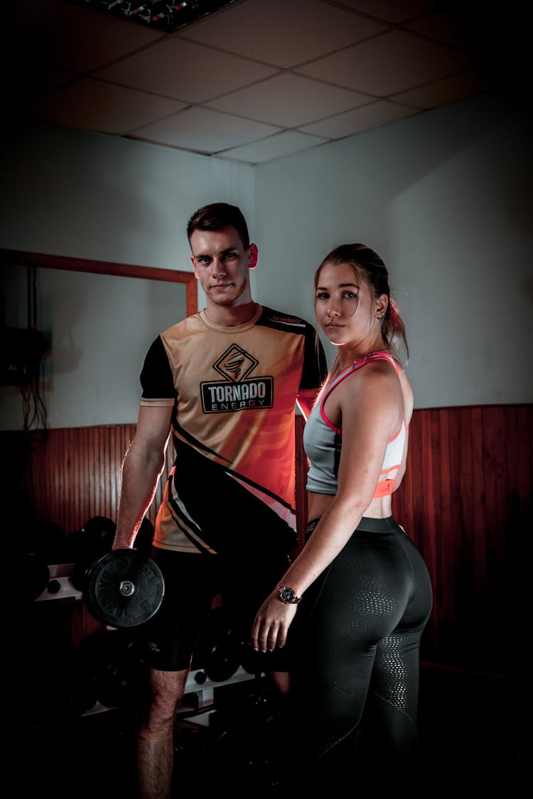 Toned Man And Woman In Gym