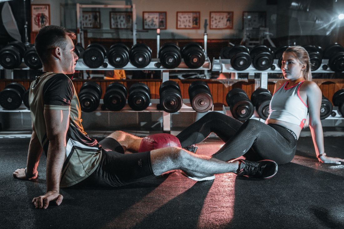 Attractive couple working out together in a gym