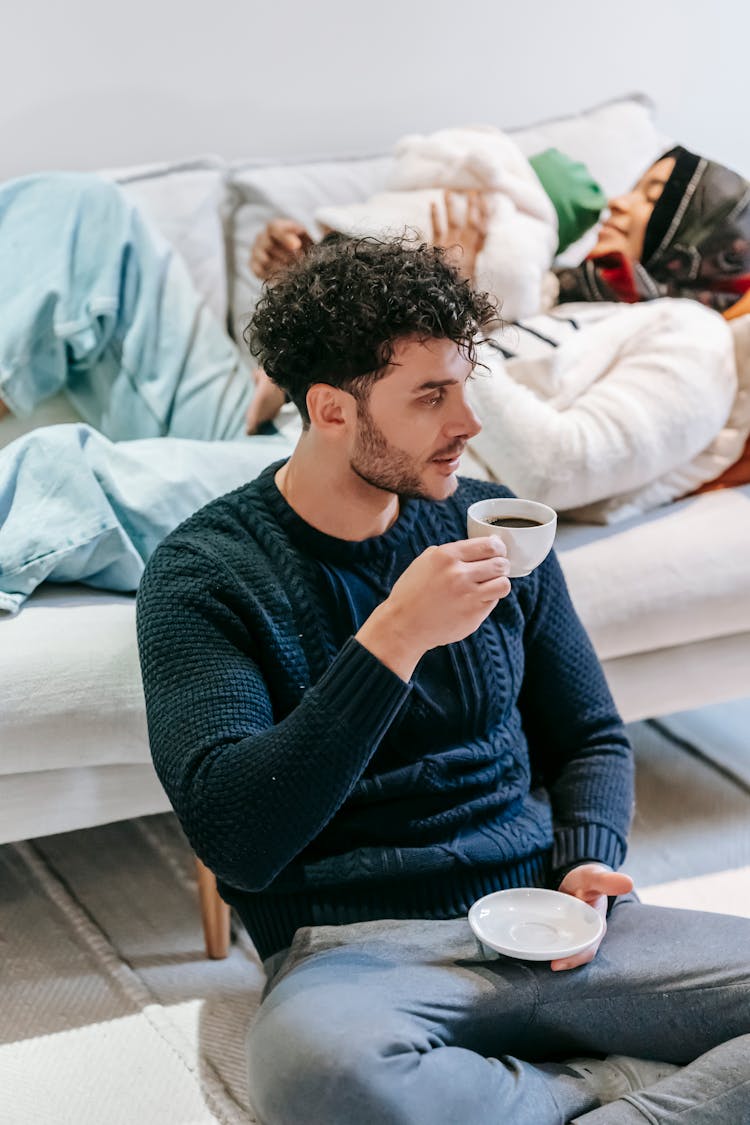 Bearded Man Drinking Coffee Sitting Near Daughter And Wife