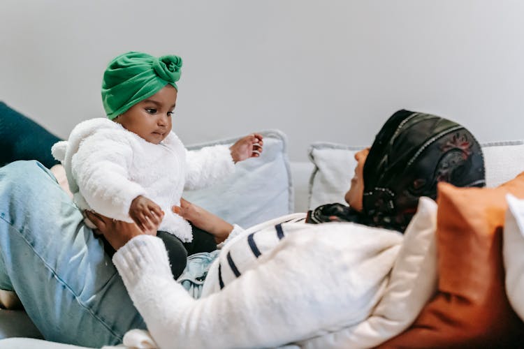 Muslim Mother Playing With Black Baby