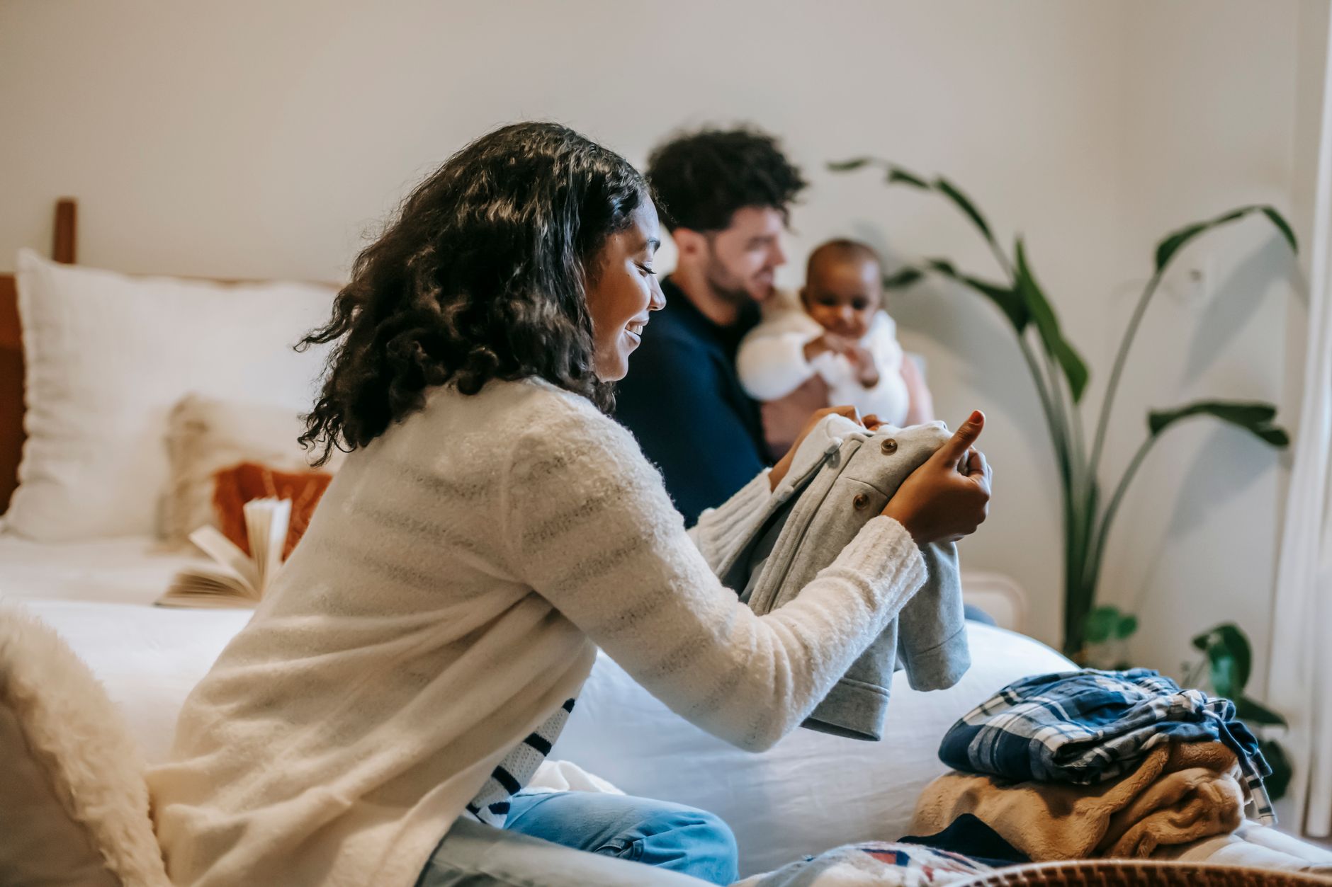 A parent sorting through children's clothes at home