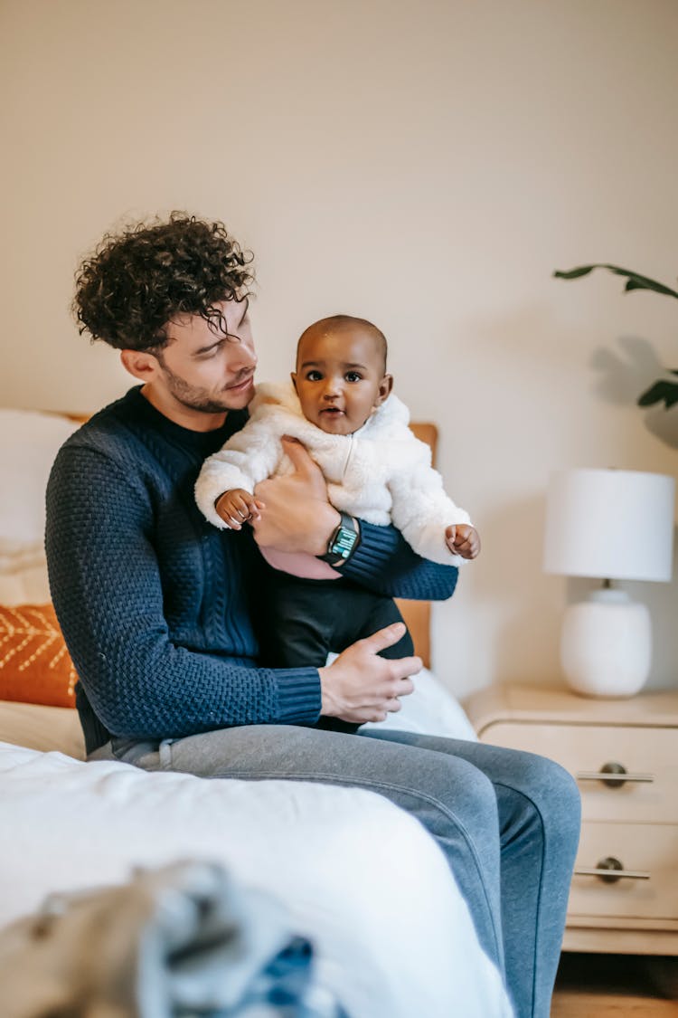 Caring Ethnic Father With Newborn Black Baby