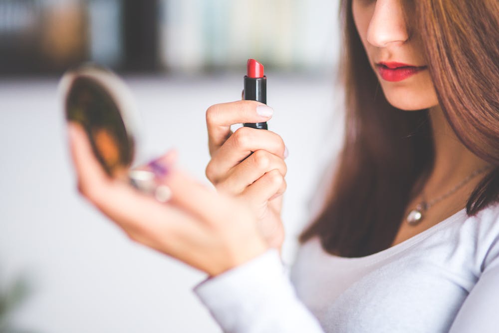 A woman applying makeup. | Photo: Pexels