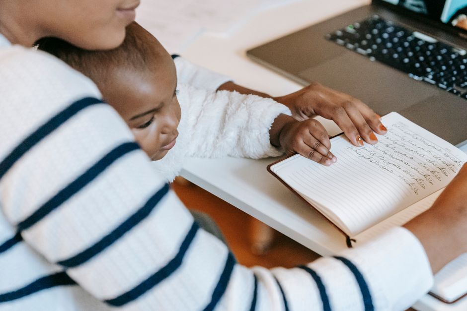 mother writing review laptop baby