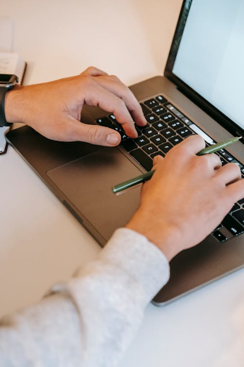 Entrepreneur typing on laptop during work
