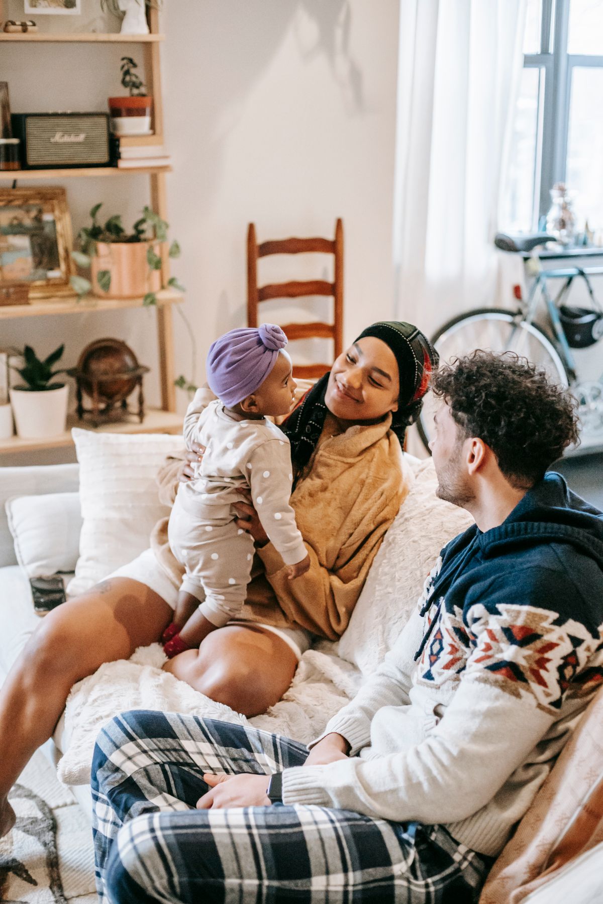 A family relaxing together on a couch in a warm, comfortable home