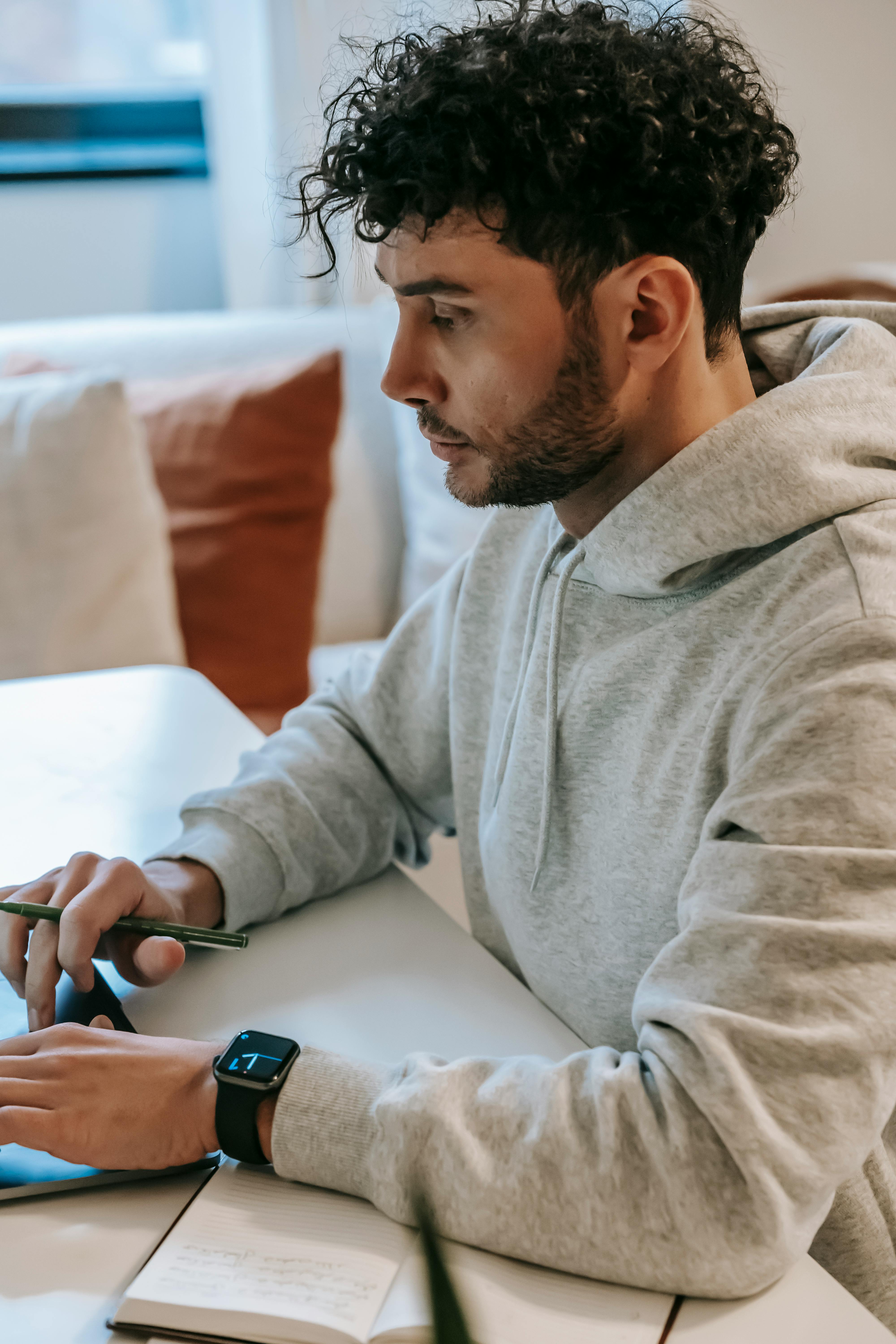 serious employee working on laptop in house