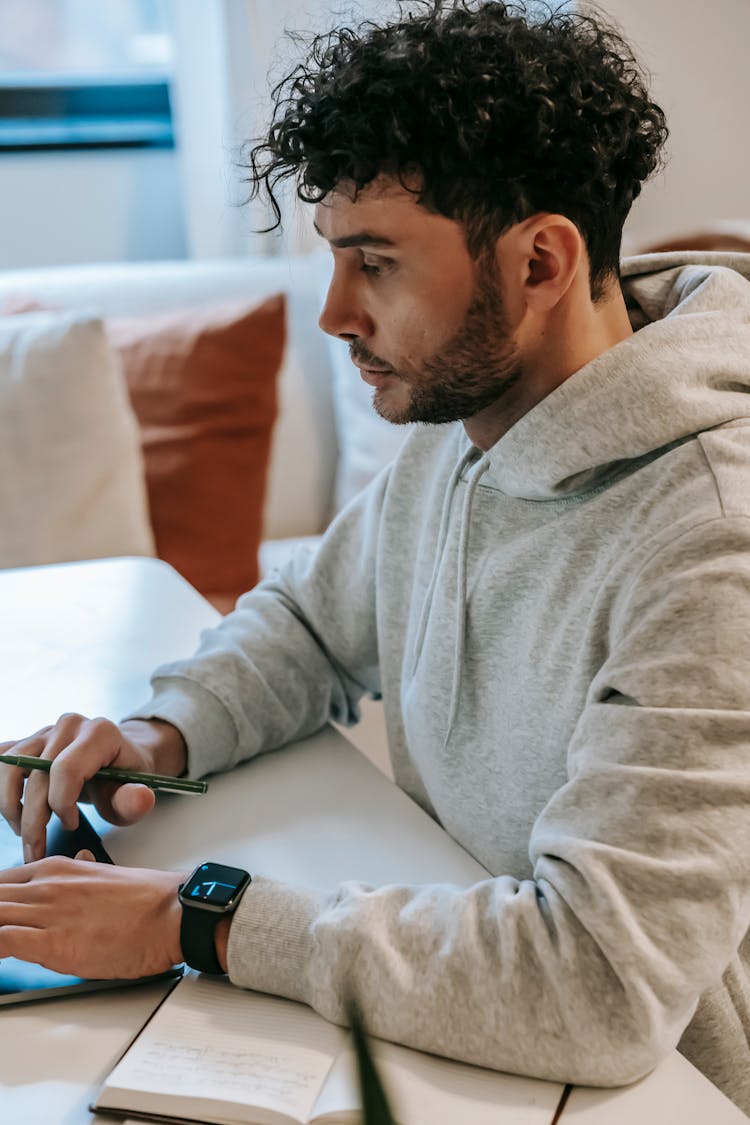 Serious Employee Working On Laptop In House