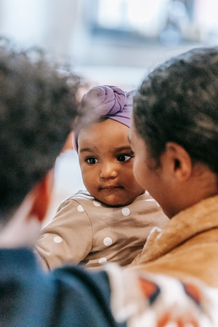 Crop Diverse Parents With Cute Baby In Headscarf