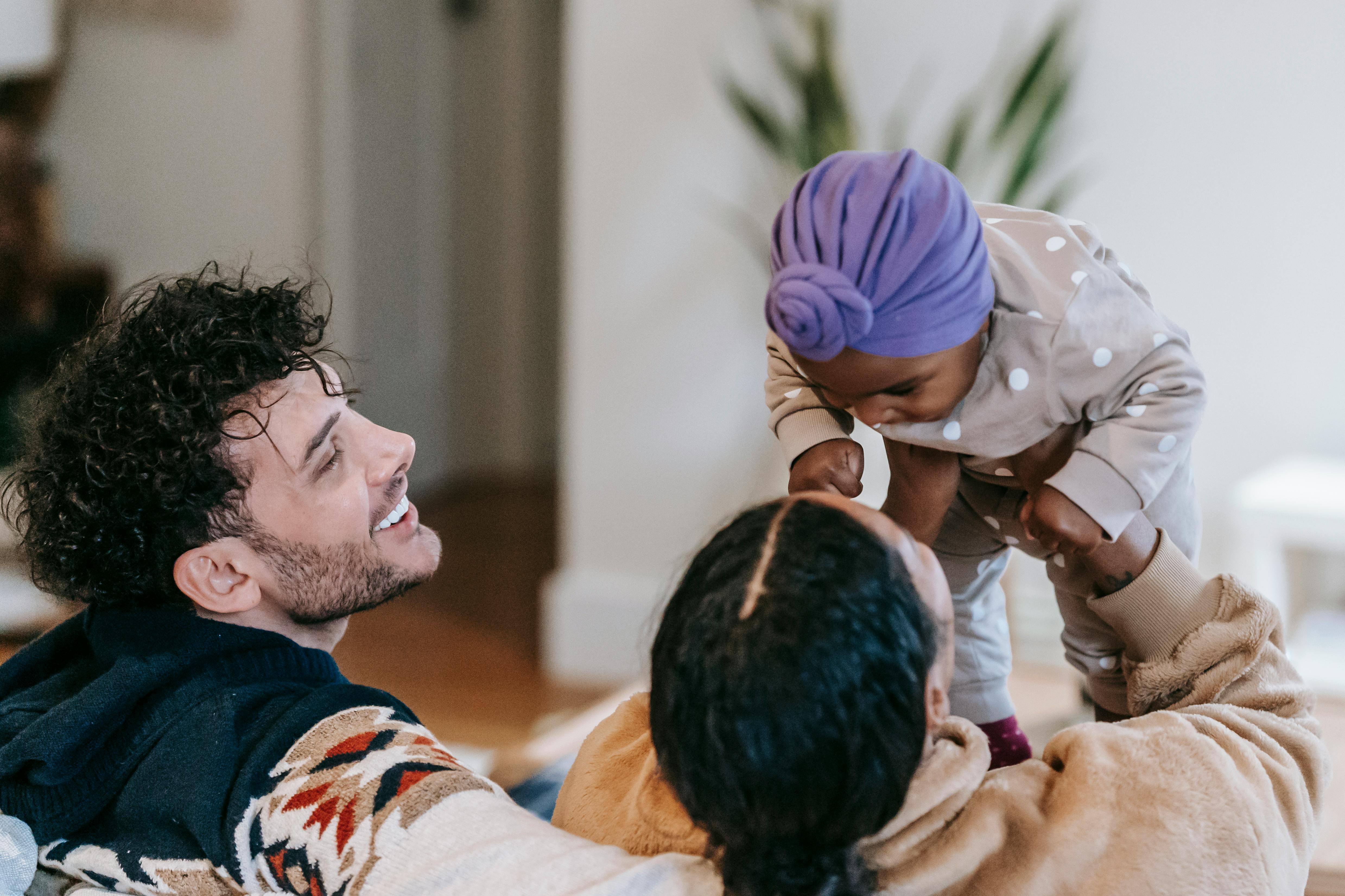 unrecognizable black mom with toddler daughter and father at home