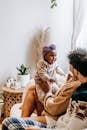 Anonymous multiracial parents interacting with crying little daughter at home