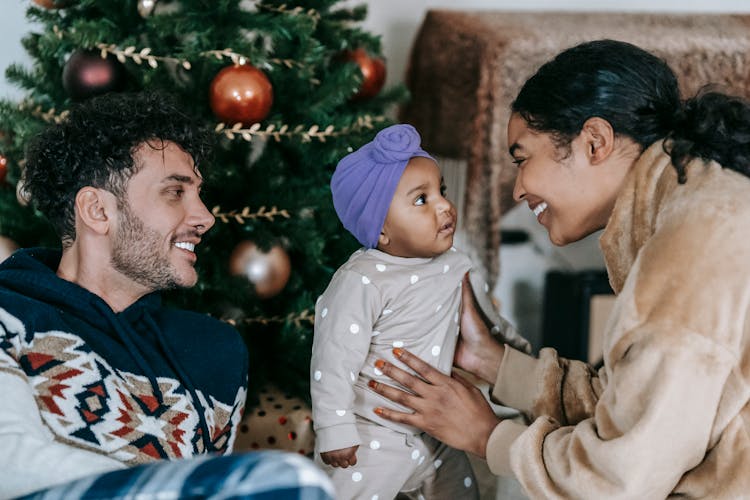 Happy Diverse Family With Baby Near Christmas Tree