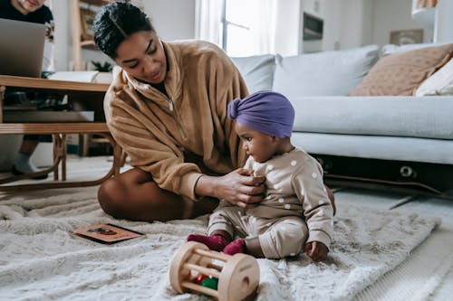 Free Mother and Baby Sitting on the Floor Stock Photo