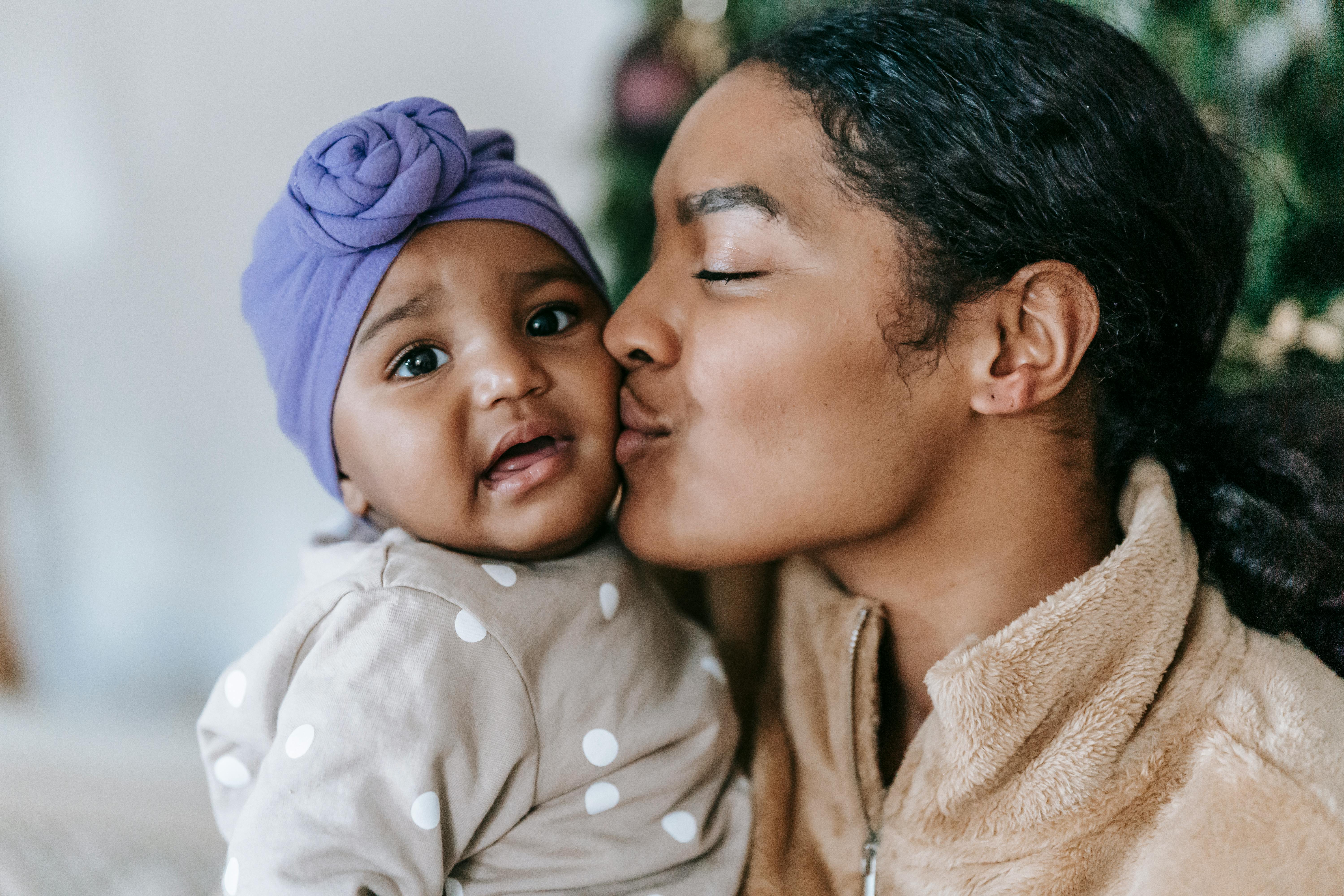 loving mother kissing her cute baby