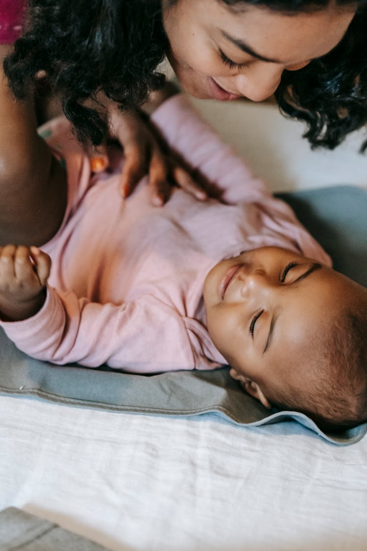 Ethnic Mother Playing With Baby At Home