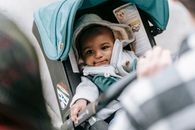 Ethnic baby in stroller with parents