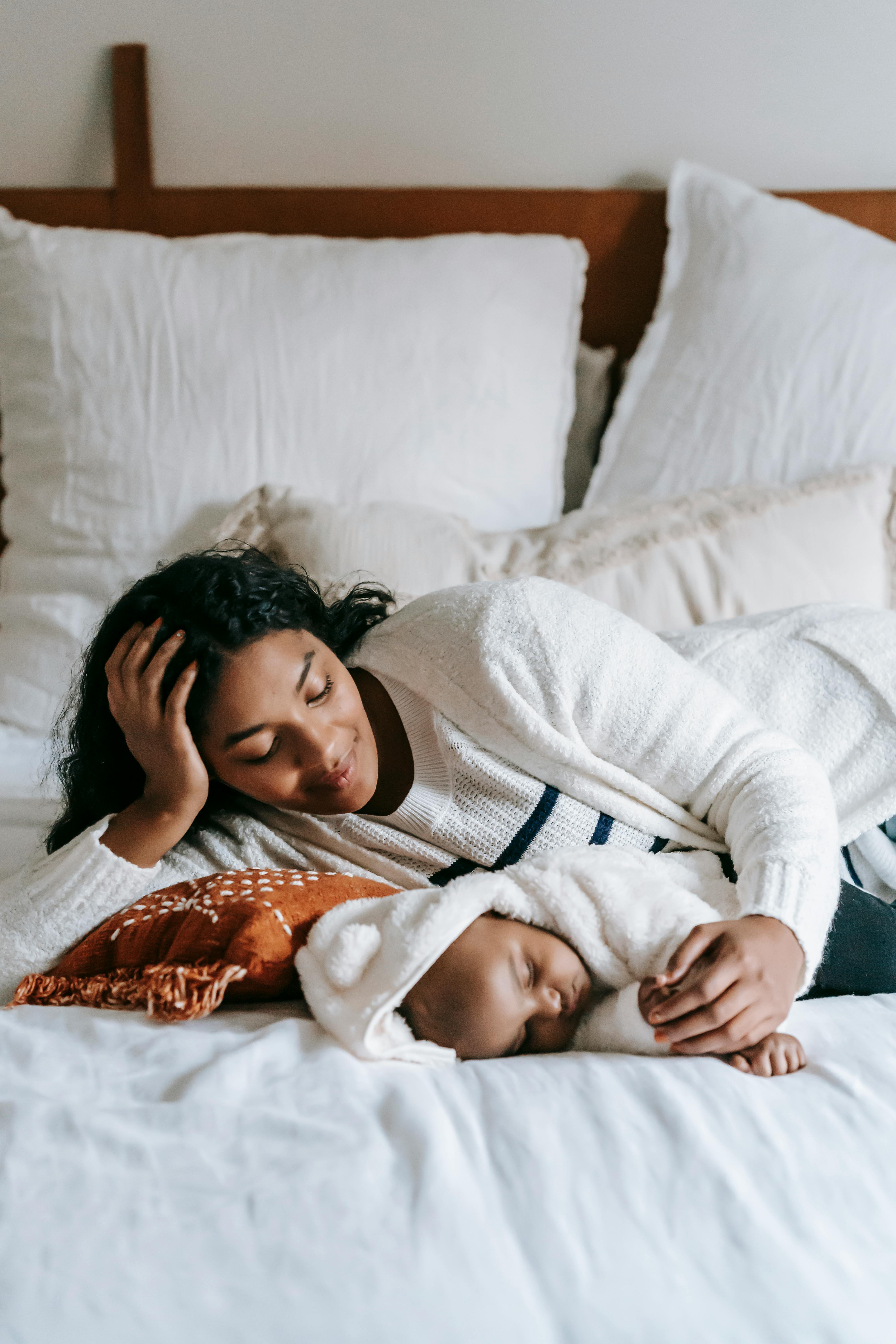 mother looking at her sleeping baby