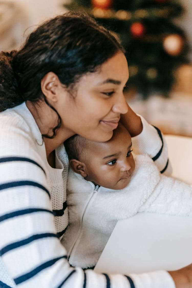 Calm Ethnic Mother Sitting With Baby