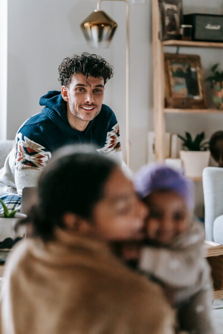 Smiling Ethnic Man Spending Time With Family At Home