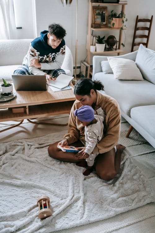 Multiethnic family with baby spending time in living room