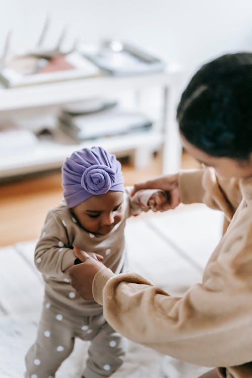 Free Mother Helping Her Baby Girl to Walk Stock Photo