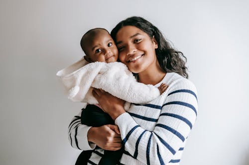 Free Smiling Mother and Baby Looking at Camera Stock Photo