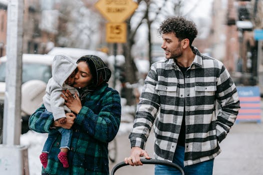 A diverse family enjoying a winter walk with their baby, capturing love and togetherness.