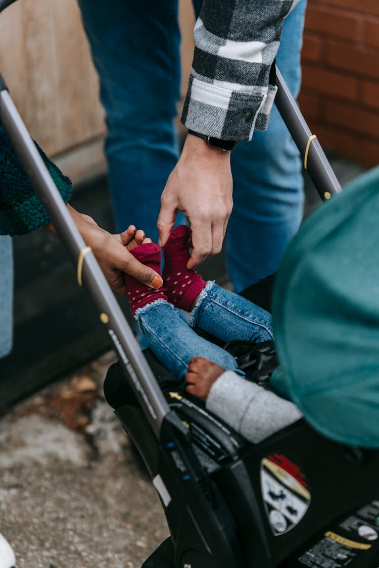 Crop Multiracial Parents With Baby In Stroller