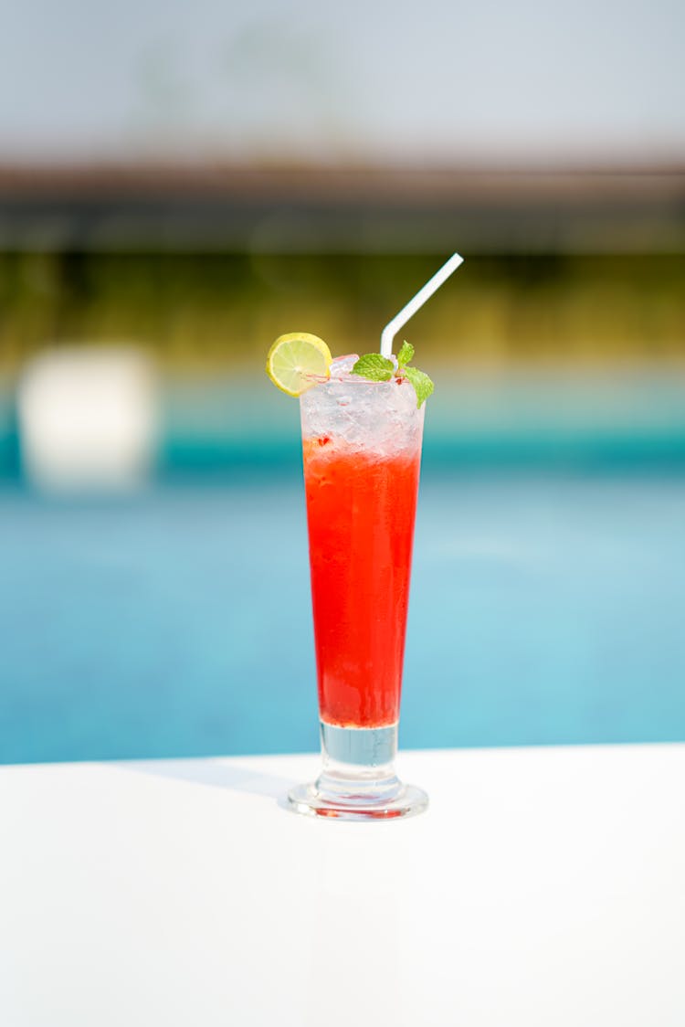 Red Refreshing Cocktail Next To A Swimming Pool 